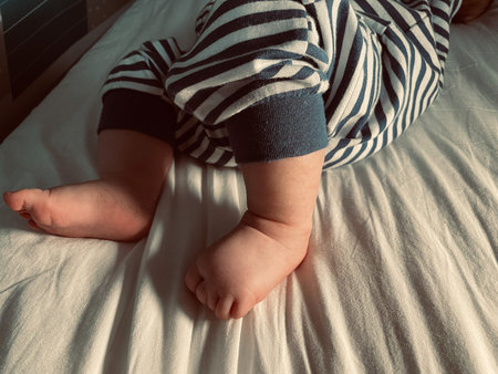 Cute small baby boy feet, candid detail of little foot toesの写真素材