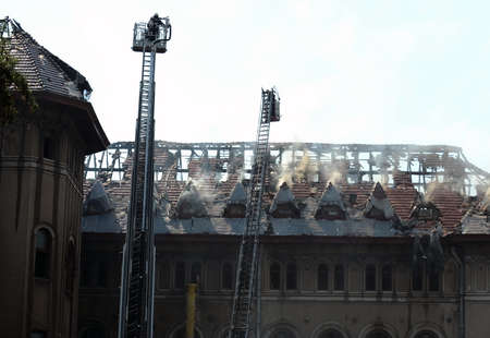 Firefighters douse a fire in an old buildingのeditorial素材