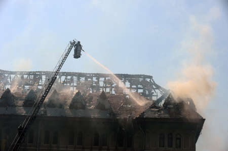 Firefighters douse a fire in an old buildingのeditorial素材