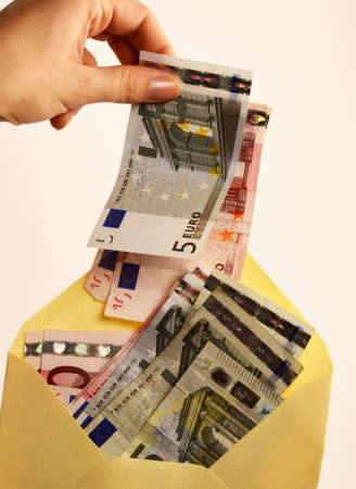 Taking out money from an envelopeの写真素材