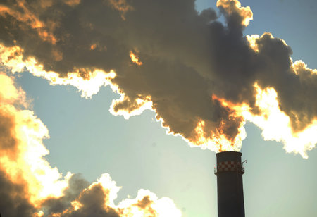 Gray smog from industrial chimneys of heating plant