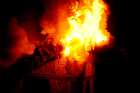 House under construction caught fire by nightの写真素材