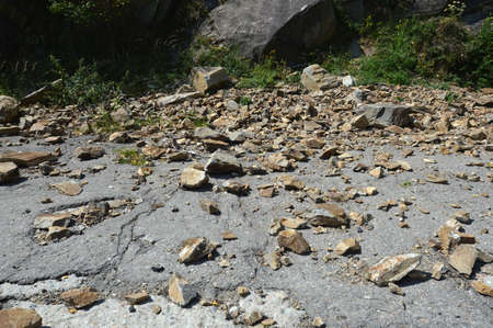 Rockfall in Carpathians where the road is covered with stonesの写真素材