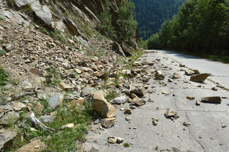 Rockfall in Carpathians where the road is covered with stonesの写真素材