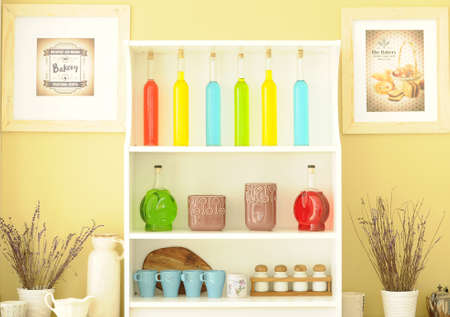 Colored bottles arranged nicely on the shelfの写真素材