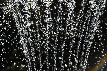 Fountain water in the night - close-upの写真素材