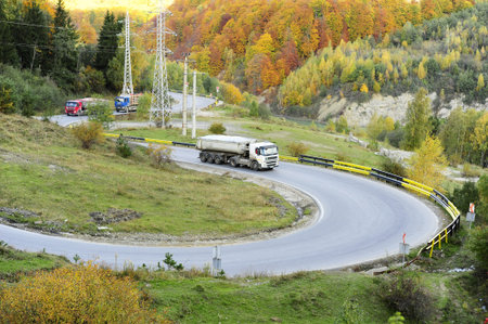 Trucks on the turning road in the mountainsの写真素材