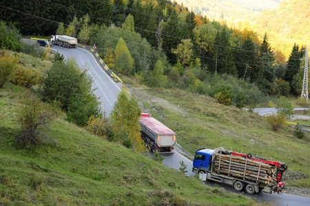 Trucks on the turning road in the mountainsの写真素材