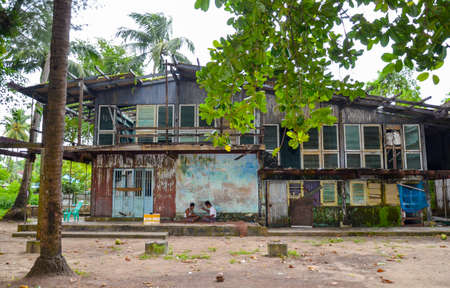 NGAPALI, MYANMAR- SEPTEMBER 27, 2016: Fishermen preparing their fishing nets in front of their houseのeditorial素材