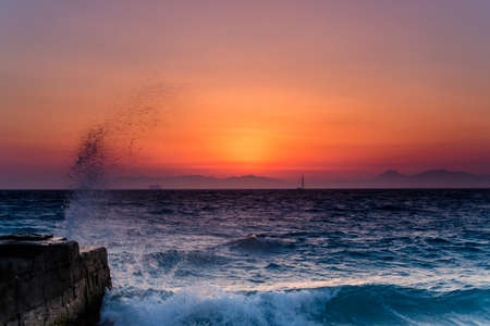 Sunset over rough seaの写真素材