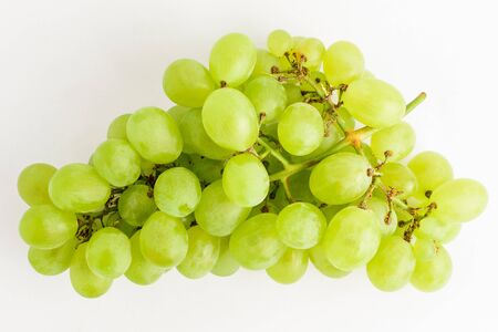 One bunch of ripe organic white grapes isolated on white background, top view or flat lay of healthy vegan foodの写真素材