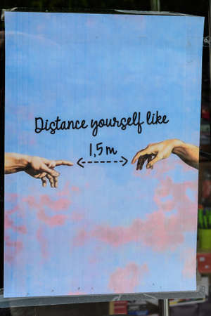 Bucharest, Romania - June 6, 2020: Poster indicating 1.5 meters social distancing request behind a store window closed down in order to mitigate the spread of the Coronavirus (COVID-19) outbreakのeditorial素材