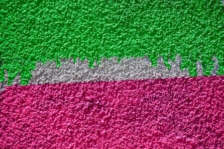 Minimalist textured background with sprayed painted wall like graffiti art, made with with vivid pink and green  colorsの写真素材