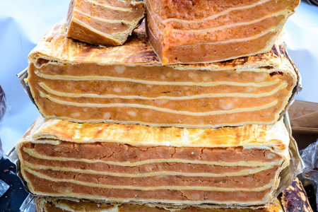 Large portions of freshly home cooked pumpkin pie in display on a table at a street food market,...