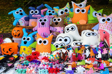 Group of colourful textile hand made decorations and toys for children, available for sale at a traditional weekend marketの写真素材