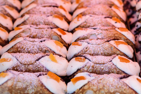 Group of freshly cooked cannoli or cannoli siciliani, traditional Sicilian pastry with ricotta and...