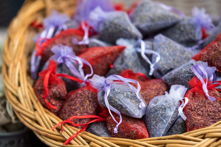 Many small lila and red sachets with dried lavender flowers, displayed for sale at an weekend deco...