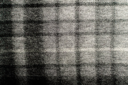 Black and grey textured textile wool material background with vertical and horizontal stripes