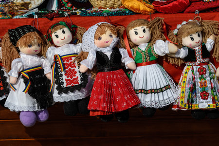 Group of colourful textile hand made decorations, dolls for children, available for sale at a...