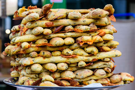 Fresh hot mini pizza baguettes in display for sale at a street food market, Italian recipe with healthy ingredients, soft focusの写真素材