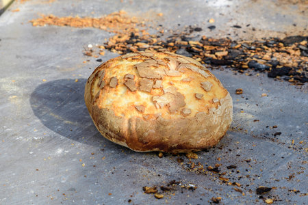 Fresh baked whole-grain bread displayed for sale at a street food market, healthy food photographed...