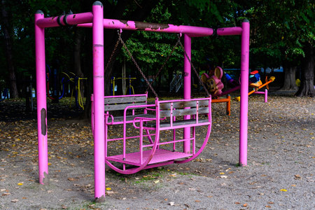 Colourful children playground with mixed plastic and metallic toys and materials in a sunny summer day in Bucharest, Romaniaの写真素材