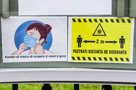 Bucharest, Romania - June 6, 2020: Mandatory 2 meters social distancing and medical protection mask at the entry into a store, to mitigate the spread of the Coronavirus (COVID-19) outbreakのeditorial素材