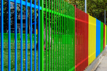 Colorful fence at a children playground with mixed plastic and metallic toys and materials in a sunny summer day in Bucharest, Romaniaの写真素材