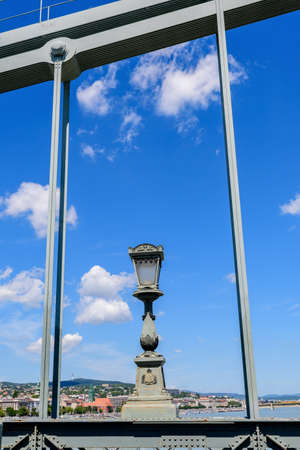 Vintage rusted lighting pole with clear blue sky in the background on SzÃ©chenyi Chain Bridge over Danube in Budapest, Hungaryの写真素材