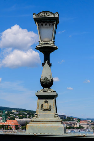 Vintage rusted lighting pole with clear blue sky in the background on SzÃ©chenyi Chain Bridge over Danube in Budapest, Hungaryの写真素材