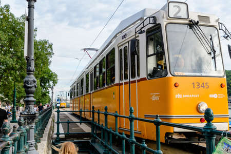 Budapest, Hungary, 6 August 2019: Historic yellow tram for passengers driving through the streets and part of the public transport system in in the old center in a sunny summer dayのeditorial素材