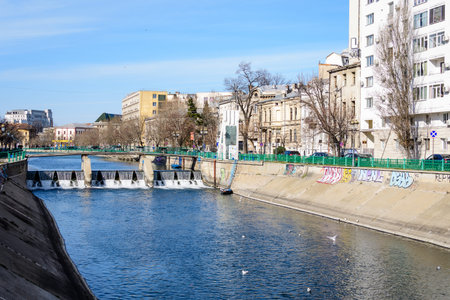 Bucharest, Romania, 13 February 2021 - Small bridge, old buildings near Dambovita river and clear blue sky in the center of Bucharest, Romania, in a sunny winter dayのeditorial素材