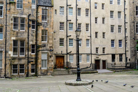 Typical old historic buildings made of stone bricks in Edinburgh city, in Scotland in a cloudy rainy summer dayのeditorial素材