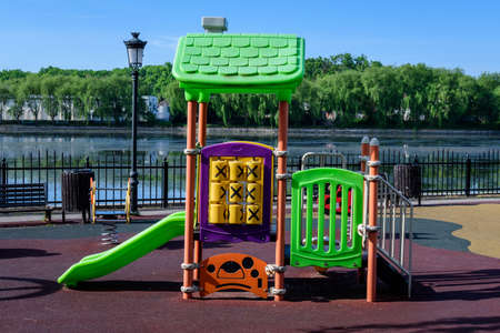 Colourful children playground with mixed plastic and metallic toys and materials in a sunny summer day in Floreasca Park in Bucharest, Romaniaの写真素材