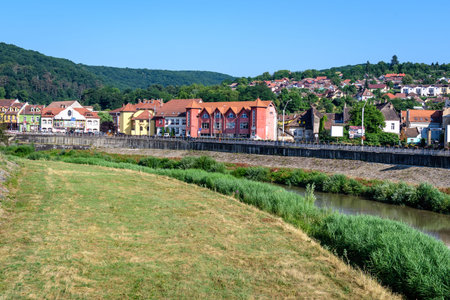 City landscape with Tarnava Mare River and blocks of flats in the center of Sighisoara, in...