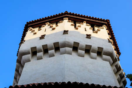 Large old white painted stone tower in the historical center of the Sibiu city, near Citadel Street and Park (Strada si Parcul Cetatii), in Transylvania (Transilvania) region of Romania, in summerの写真素材