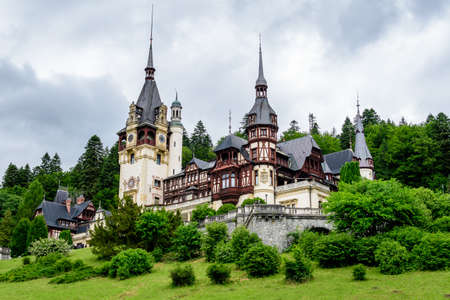 Beautiful neo-Renaissance building of Peles Castle (Castelul Peles) near Bucegi Mountains (Muntii Bucegi) in a cloudy summer day in Sinaia town, Romaniaのeditorial素材