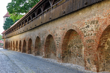 Old red bricks defence wall on Strada Cetatii (Citadel Street) in the historical center of the Sibiu city in Transylvania (Transilvania) region of Romania, in a sunny summer dayのeditorial素材