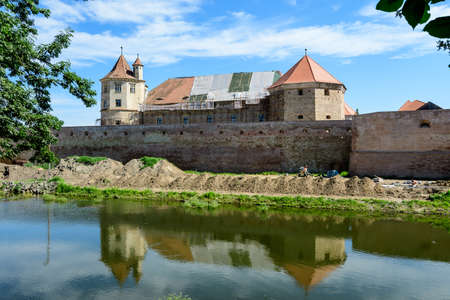 Renovated old historical buildings  of Fagaras Fortress (Cetatea Fagaras) during renovation works in a sunny summer day, in Transylvania (Transilvania) region, Romaniaのeditorial素材