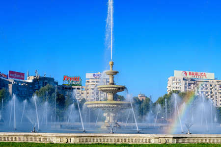 Bucharest, Romania, 4 September 2021: Decorative fountain with small water drops in Unirii Square (Piata Unirii) in the city center, in a sunny autumn dayのeditorial素材