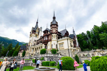 Sinaia, Romania - 3 July 2021: Beautiful neo-Renaissance building of Peles Castle (Castelul Peles) near Bucegi Mountains (Muntii Bucegi) in a cloudy summer day in Sinaia townのeditorial素材