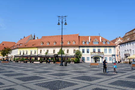 Sibiu, Romania - 15 July 2021: Renovated old historical buildings in the Large Square (Piata Mare) in Transylvania (Transilvania) region, in a sunny summer dayのeditorial素材