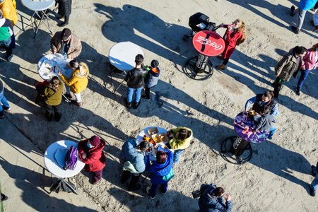 Bucharest, Romania - 28 November 2021: View from above of people eating at Christmas Market in...
