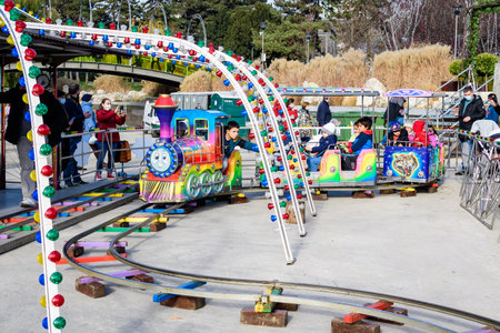 Bucharest, Romania - 28 November 2021: Colorful children train with toys at a Christmas Market in Drumul Taberei Park (Parcul Drumul Taberei) also known as Moghioros, in a sunny autumn dayのeditorial素材