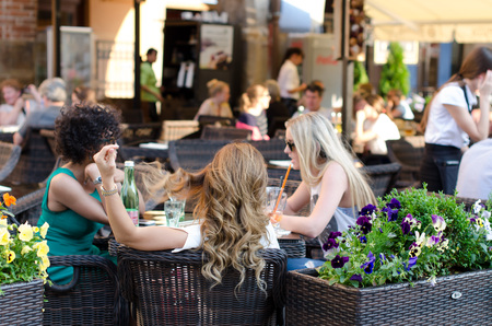 Prague, Czech Republic - June 30: Three women sit at the table and talk on June 30, 2015 in Prague, Czech Republic.のeditorial素材
