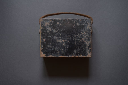 Antique storage case for an old analog voltmeter, showing signs of age and long-term use.の写真素材