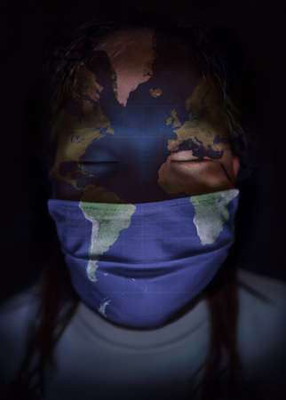Teenager with closed eyes, with mask and face painted with world mapの写真素材