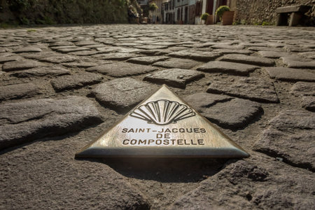 Mark in the form of a metal triangle on the ground indicating the way to Santiago de Compostela in...