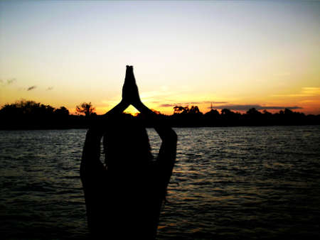 Woman praying at duskの写真素材