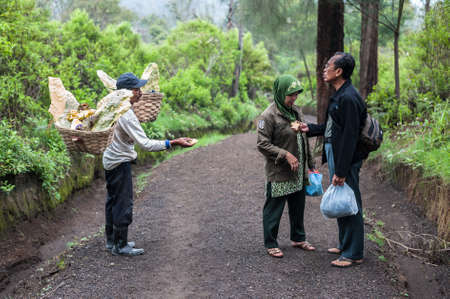 Worker at Ijen crater sells souvenirs to touristsのeditorial素材